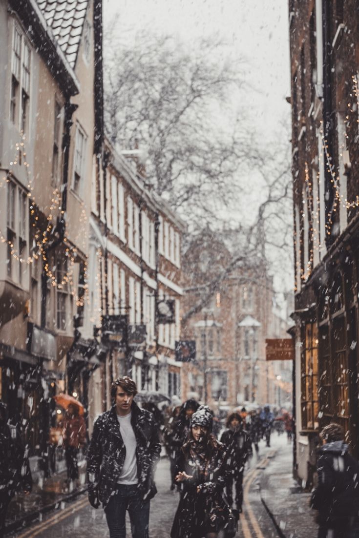 Snowy street in the UK with crowds