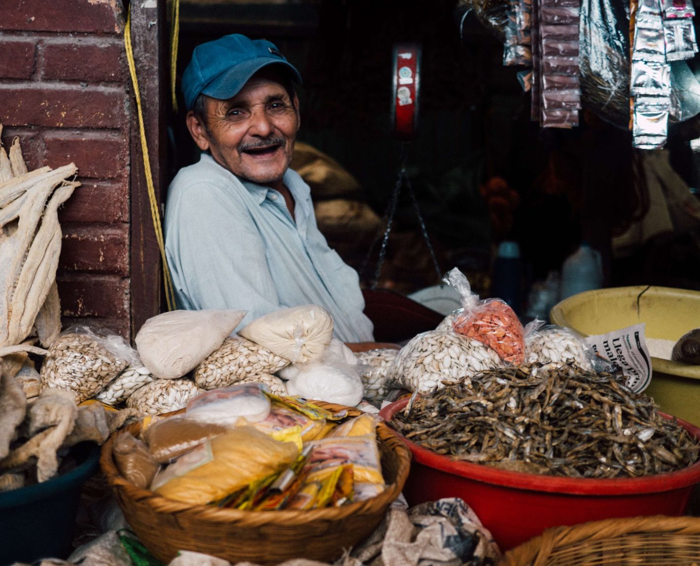 man selling food at a market in Honduras