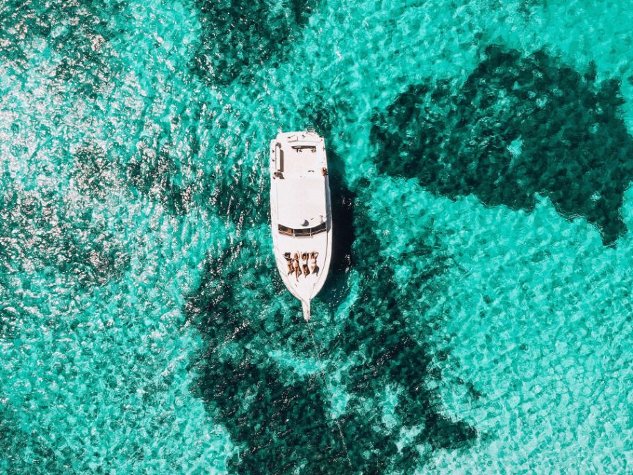 boat in blue water in Roatan Island, Honduras