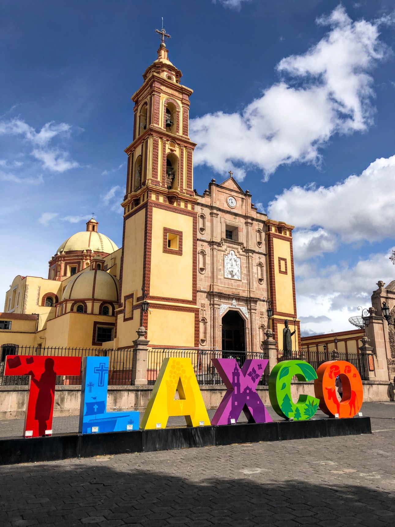 Tlaxco colorful city sign and yellow central church
